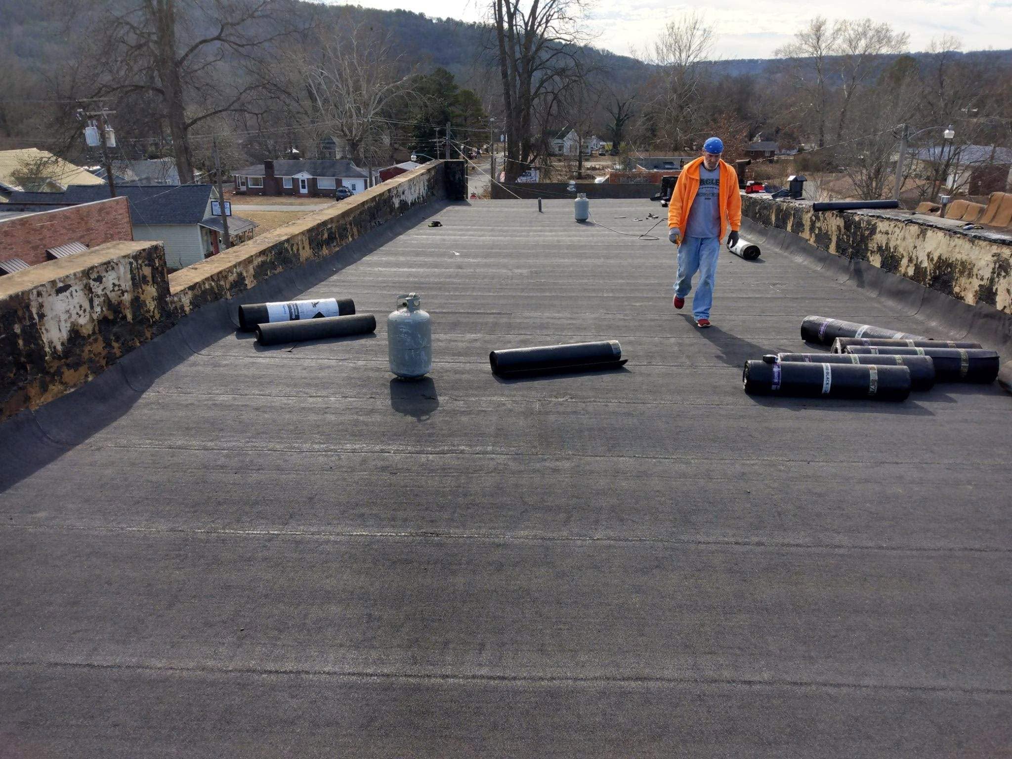 Crew member working on a commercial flat roof